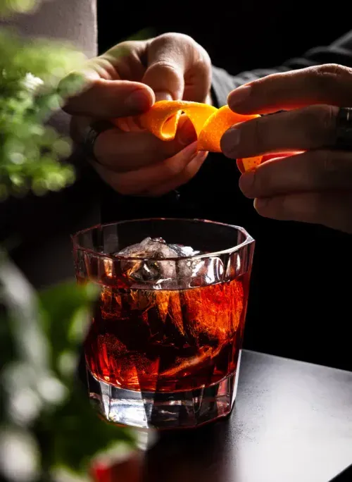 Winter Negroni with orange zest over a large ice cube